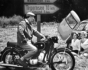 Motorcycle versus car: At the ends of the 50s compact cars became affordable vehicles for the masses.