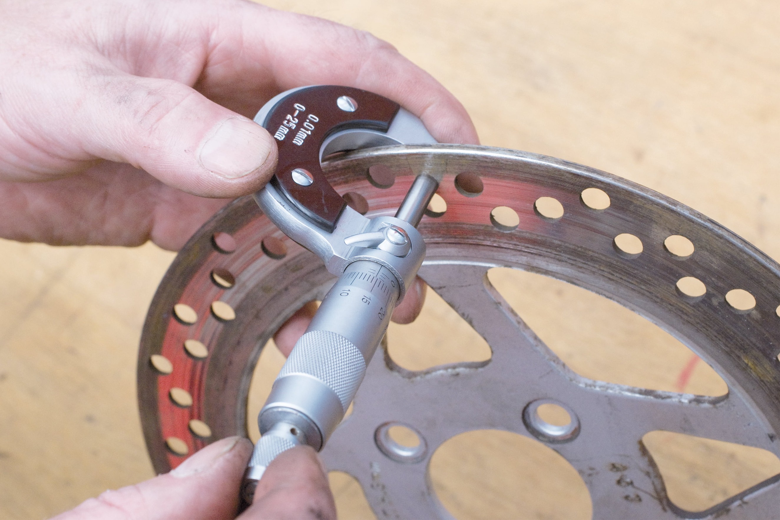 Step 4: Use a micrometer to check the brake disc