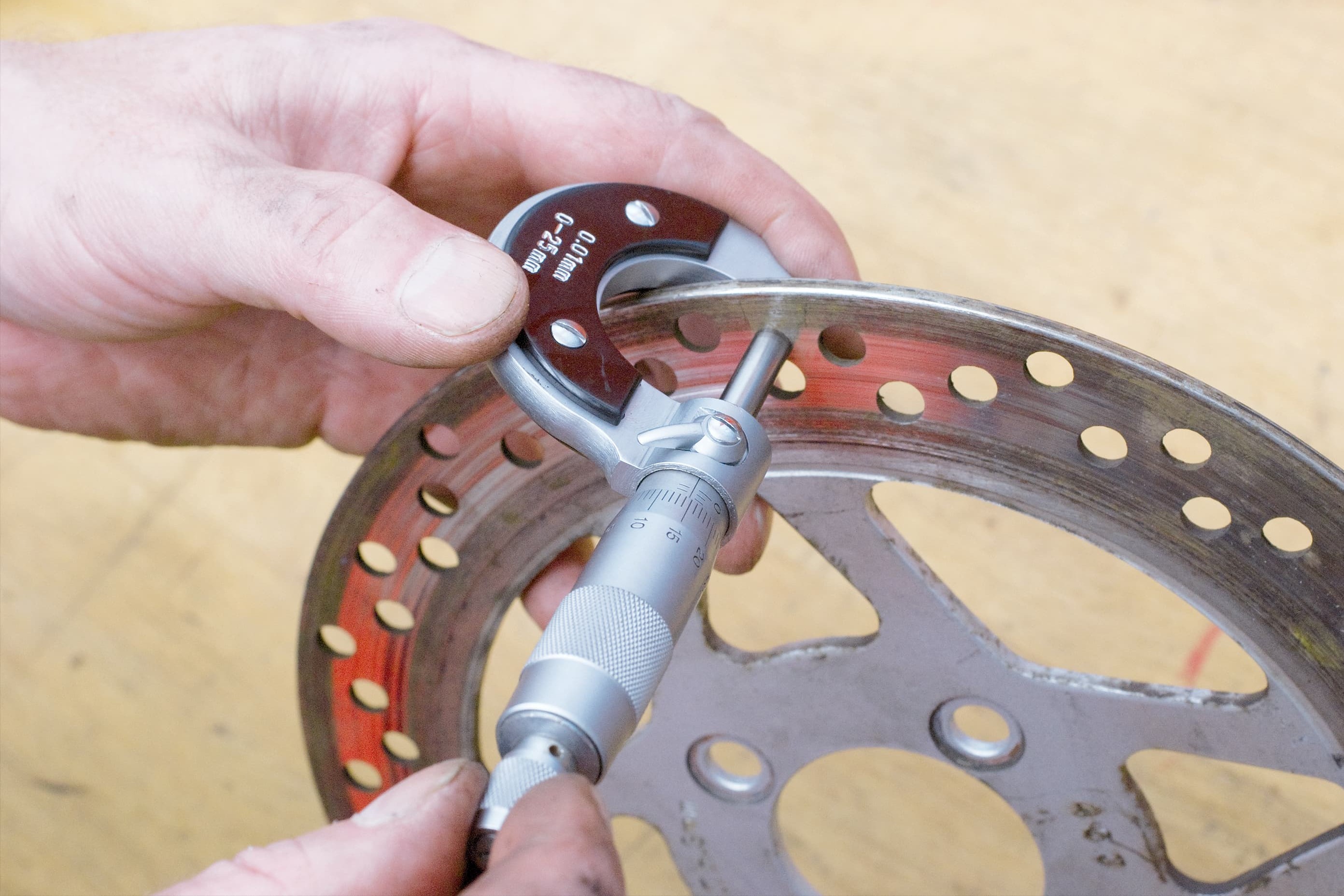 Use a micrometer to check the brake disc