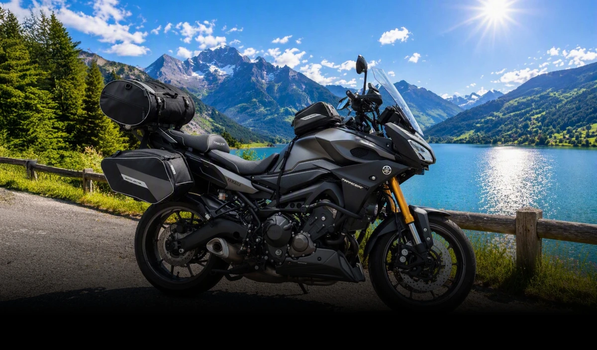 KI generiert: Ein schwarzes Motorrad mit Gepäck steht an einer Straße mit Blick auf einen See und Berge im Hintergrund. Die Sonne scheint hell am klaren Himmel.